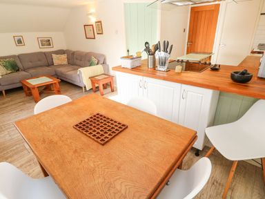 A living area with a sofa and dining table at Five Elements Barn in Truro