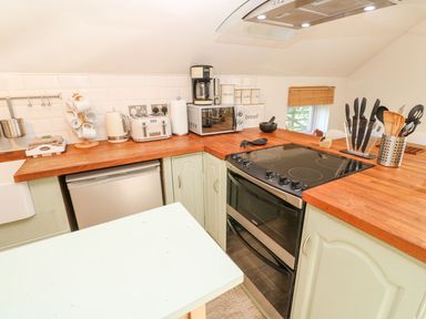A kitchen with various appliances and utensils at Five Elements Barn in Truro
