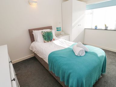 A bedroom with a bed and wardrobe at Five Elements Barn in Truro