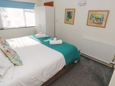 A bedroom with a bed and wardrobe at Five Elements Barn in Truro
