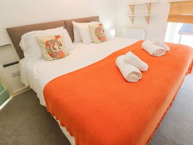 A bedroom with a bed and towels at Five Elements Barn in Truro