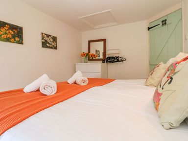 A bedroom with a bed and decorative pillows at Five Elements Barn in Truro