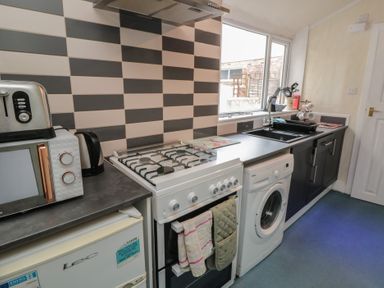 A kitchen with appliances and cabinets at 170 Victoria Road