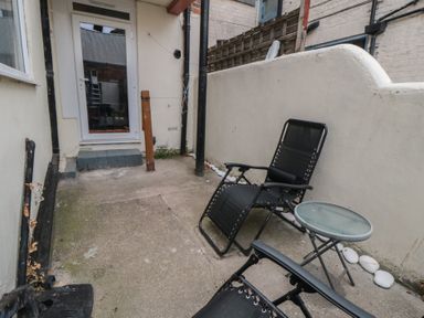 An outdoor area with chairs and a table at 170 Victoria Road