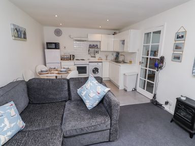 A kitchen with appliances and furniture at 51 Longstone Park