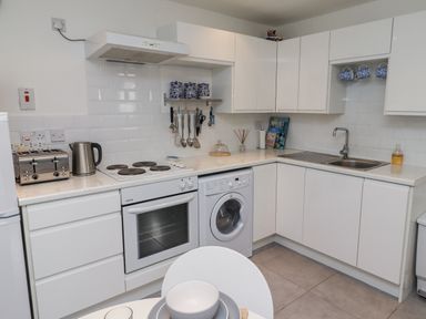 A kitchen with modern appliances at 51 Longstone Park