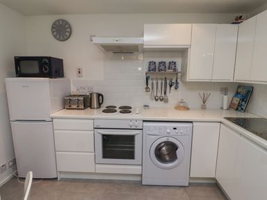 A kitchen with appliances and utensils at 51 Longstone Park
