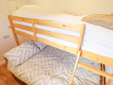 A bunk bed with a mattress and pillow at 66 Cherry Park Skegness