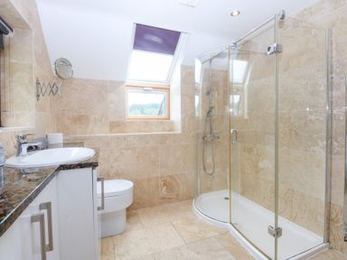 A bathroom with a shower and sink at Ty Newydd Llanrhychwyn near Llanrwst