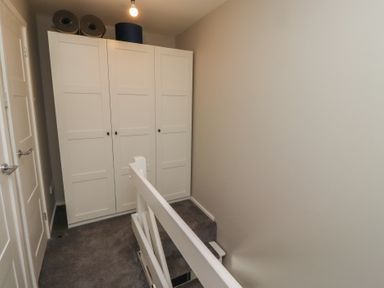 A landing area with a wardrobe and stairs at 3 Longstone Park Beadnell