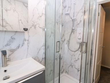 A bathroom featuring a shower and sink at Seaspray in Beadnell