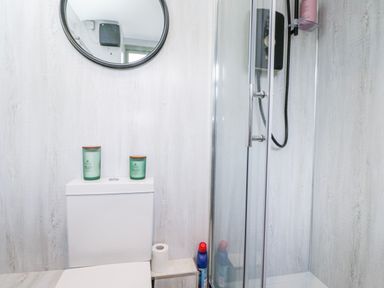 A bathroom with a toilet and shower at Firefly Cottage