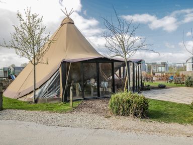 A tent structure with patio and grass at Firefly Cottage