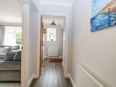 A hallway with a couch and windows at Woodlark