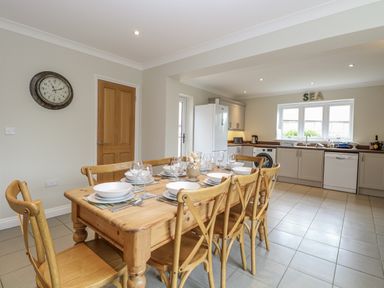 A kitchen with a dining table and chairs at Woodlark