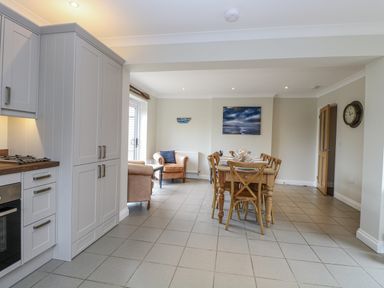 A kitchen with a dining area and seating at Woodlark