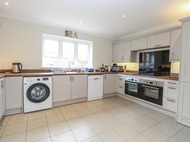 A kitchen with appliances and cabinets at Woodlark