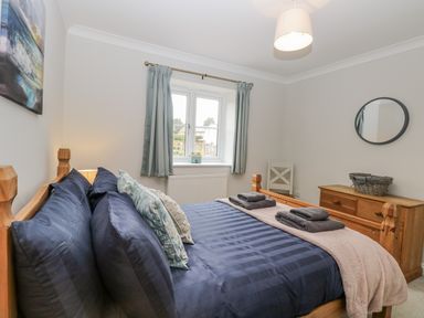 A bedroom with a bed and window at Woodlark