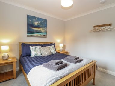 A bedroom with a bed and bedside tables at Woodlark