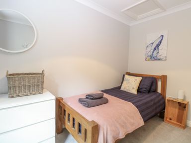 A bedroom with a bed and a mirror at Woodlark 