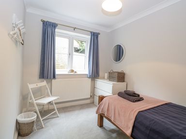 A bedroom with a bed and chair at Woodlark