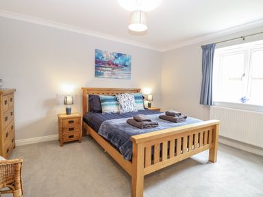 A bedroom with a bed and bedside furniture at Woodlark