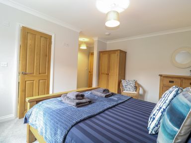A bedroom with a bed and wardrobe at Woodlark