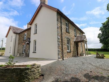 A house with stone exterior and patio area at The Sycamores in Llawhaden near Narberth