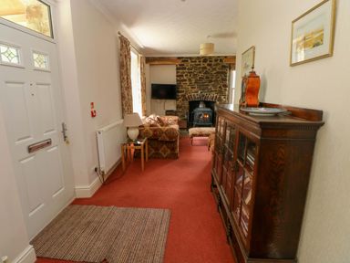 A living room with a sofa and television at The Sycamores in Llawhaden near Narberth
