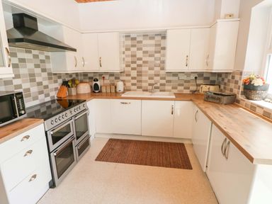 A kitchen with cabinets and appliances at The Sycamores Llawhaden near Narberth