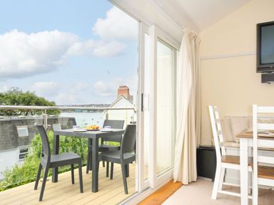 A dining area with outdoor table and chairs at 9 Slipway Cottages Rock