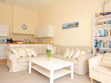 A living room with a sofa and coffee table at 9 Slipway Cottages Rock