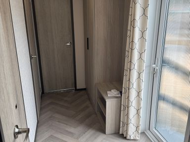 A hallway with a door and a window at Lime Tree Lodge