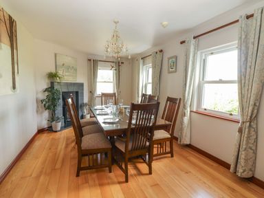 A dining room with a table and chairs at Ash House in Ballyvaughan