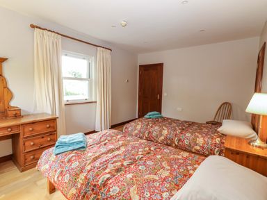 A bedroom with two beds and a dresser at Ash House in Ballyvaughan