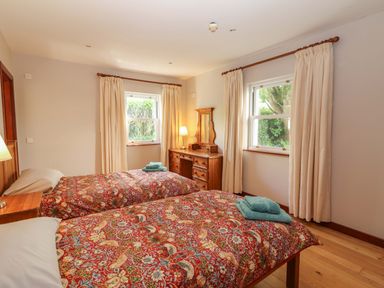 A bedroom with two beds and a dresser at Ash House in Ballyvaughan