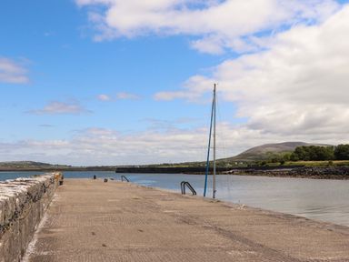 A pier with a sailboat at Ash House in Ballyvaughan