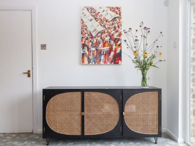 A hallway with a cabinet and flowers at Tigley Meadow Coach House in Totnes