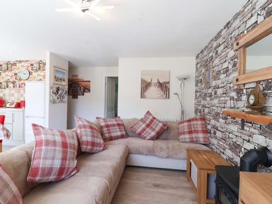 A living room with a sofa and coffee table at Boo’s Bungalow in Callington near Gunnislake