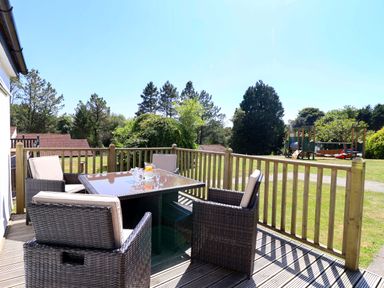 An outdoor seating area with a table and chairs at Boo’s Bungalow in Callington near Gunnislake
