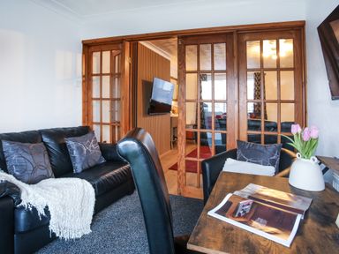 A living room with a sofa and a table at Penrhos Walks in Holyhead