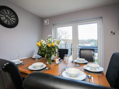A dining room with a table set for meals at Penrhos Walks Holyhead