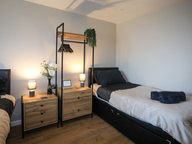 A bedroom with two beds and nightstands at Penrhos Walks in Holyhead