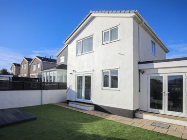 A house with a garden and patio at Penrhos Walks in Holyhead