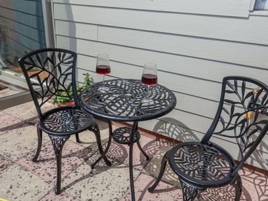 A table and two chairs with glasses on it at Holly Farm near Brantham