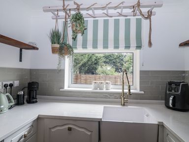 A kitchen with a sink and appliances at Holly Farm near Brantham