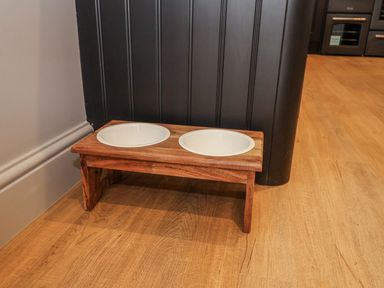 A pet feeding stand with ceramic bowls at Holly Farm near Brantham