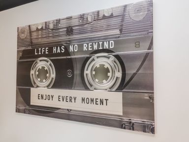 A wall art piece featuring a cassette tape design and motivational text at Holly Farm near Brantham