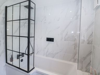 A bathroom with a shower and bathtub at Holly Farm near Brantham