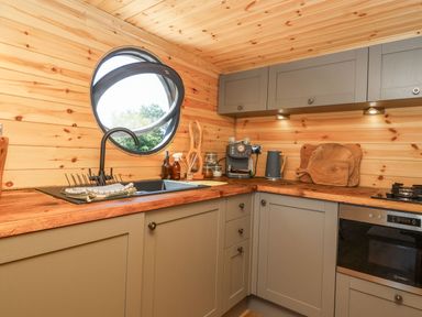 A kitchen with a sink and coffee maker at Bugley Pools Hideaway in Bugley near Gillingham